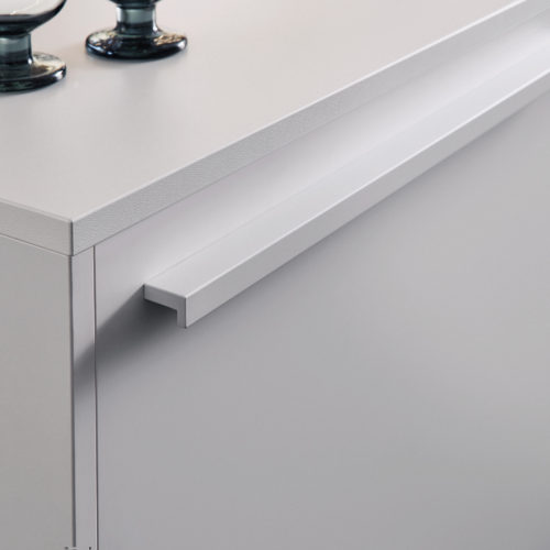 alt="Close up view of BONDI white matte-lacquer cabinet face with griprail handle"