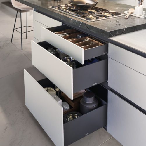 alt="close up view of open drawers beneath stove top"