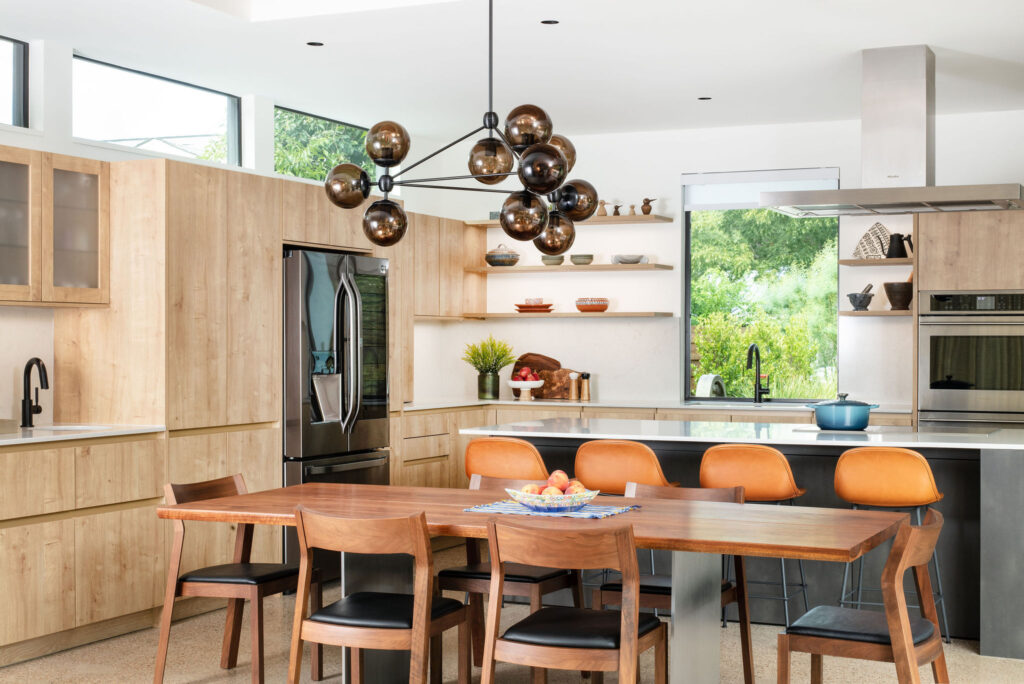 Stunning luxury kitchen remodel in Austin with natuarl wood tones and vibrant orange accents.